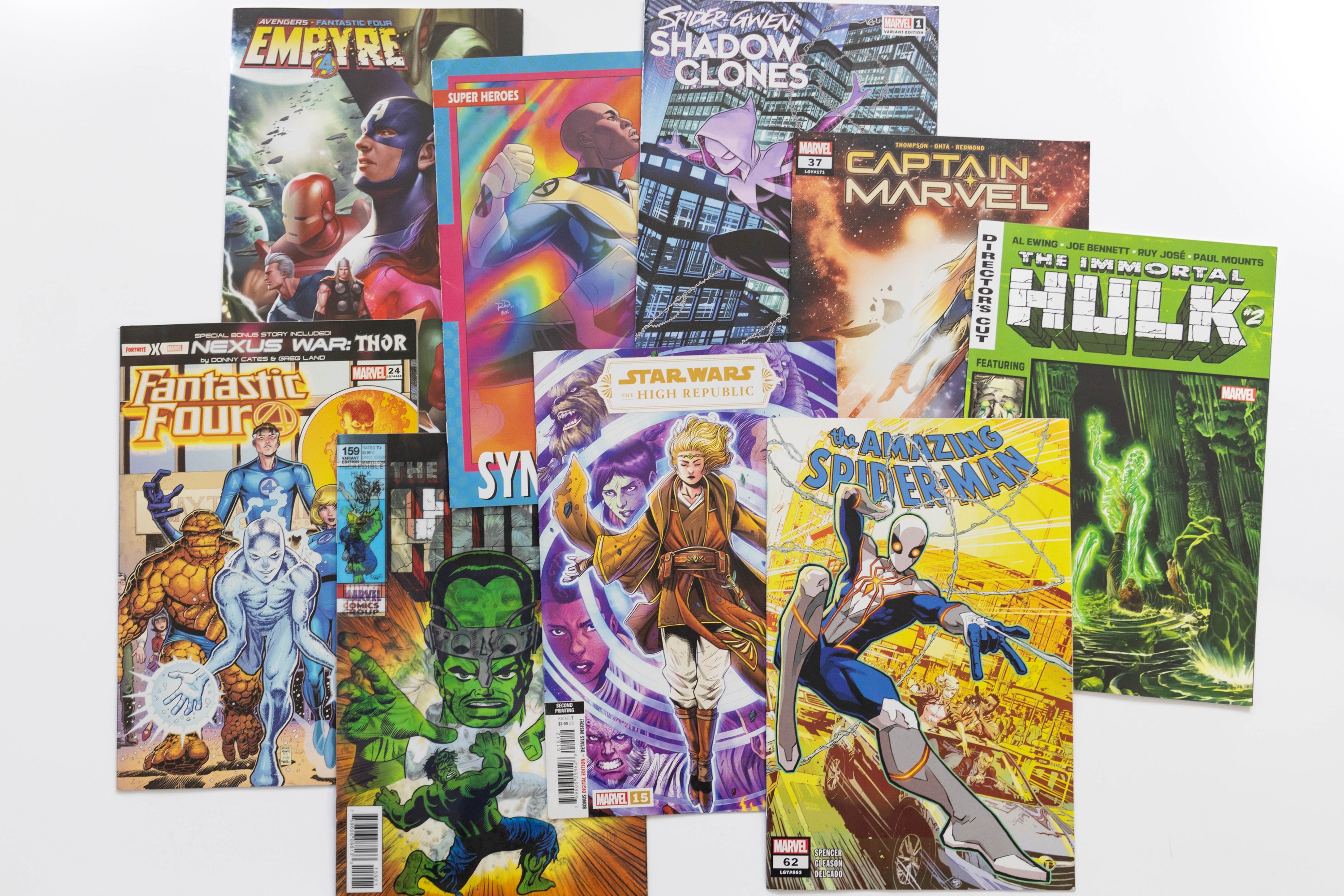 Collection of comic books featuring various superhero characters on a white background